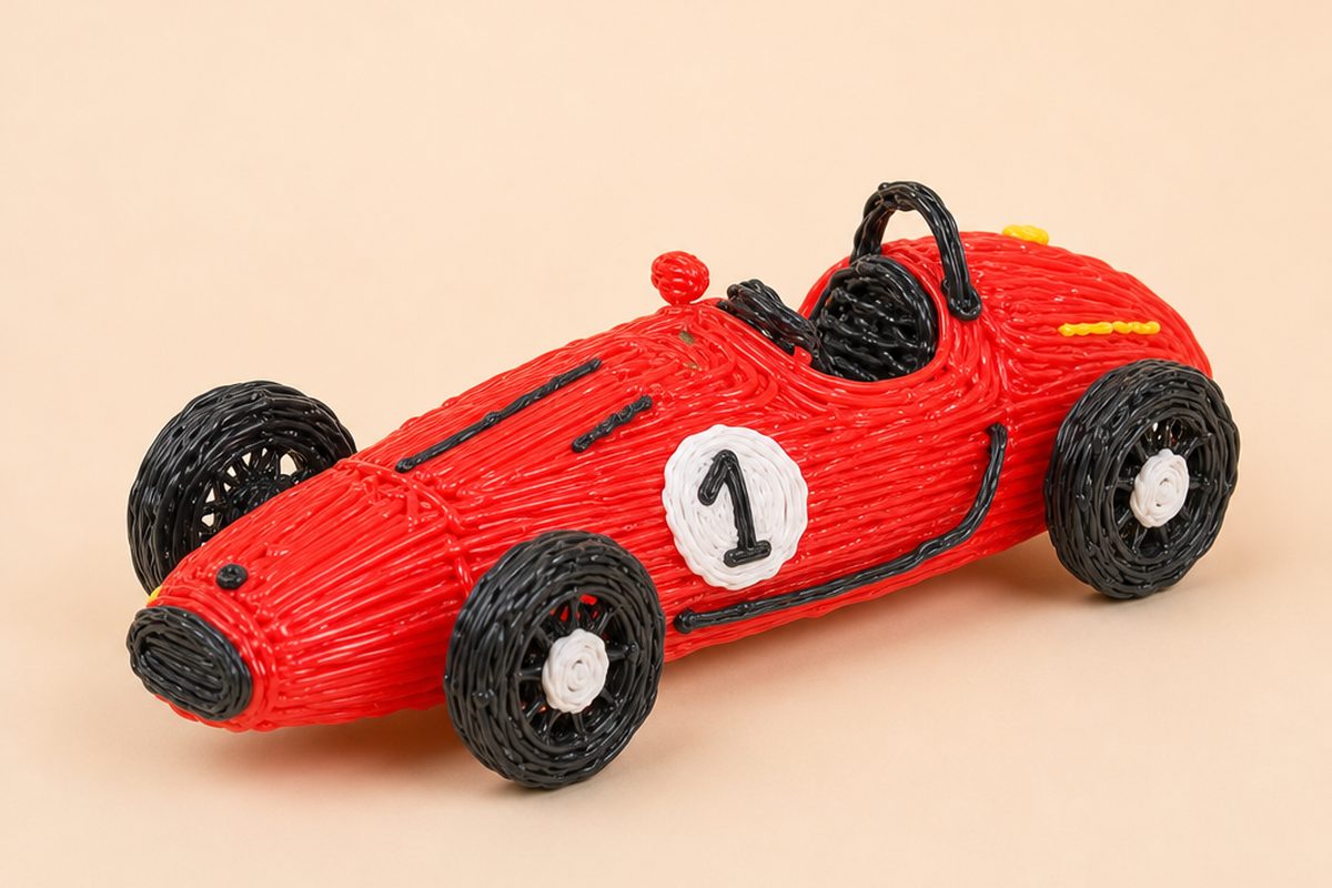 Un'auto da corsa rossa in stile vintage, creata con una penna 3D